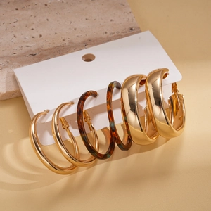 Detailed view of 3-pair earring set featuring gold hoops and tortoise shell resin rings