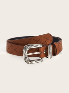 Detail shot of the engraved silver buckle and brown embossed leather texture on the belt