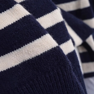 Navy and cream striped knit sweater featuring soft texture and ribbed hem detail