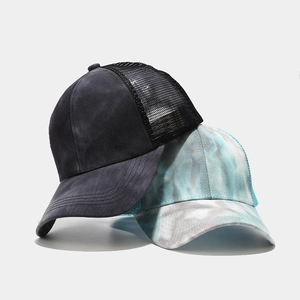 Women's trucker hats in washed black and tie-dye blue with mesh back and curved brim