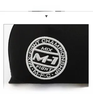 Close-up of black baseball cap with M-1 Mix-Fight Championship embroidery patch detail