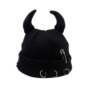 Black knit beanie featuring devil horn accents, distressed holes and silver safety pin decor