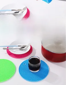 Close-up of honeycomb silicone heat-resistant mats in pink, green, and blue colors