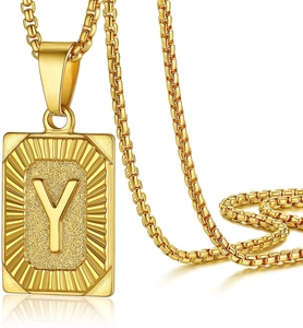 Close-up of square gold letter Y pendant with matte texture and radial edges on box chain
