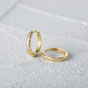 Minimalist sterling silver gold plated hoop earrings with shimmering cubic zirconia