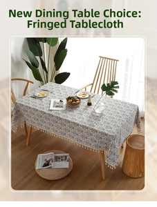 Detailed top view of blue floral cotton linen tablecloth with white pom-pom tassel edges