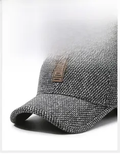 Close-up of textured tweed baseball cap with premium brown leather logo patch detail