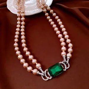Elegant double-layer champagne pearl necklace with green emerald pendant and diamonds