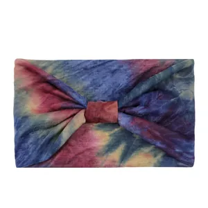 Macro detail of tie-dye elastic headband showing vibrant blue and magenta knit fabric texture