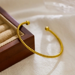 18k gold plated stainless steel twisted open bangle featuring elegant double sphere ends