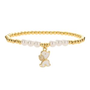 Beaded gold bracelet with white pearls and a cute white enamel dog pendant with rhinestones