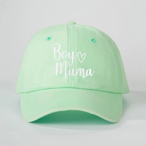 Detailed close-up of white Boy Mama embroidery on mint green washed cotton baseball cap