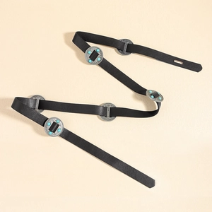 Detail of black leather belt featuring silver metal disks with turquoise beads and black gems