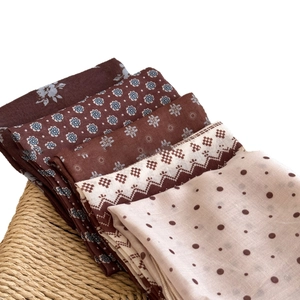 Polka dot and floral cotton linen square scarves collection in earthy tones on woven chair