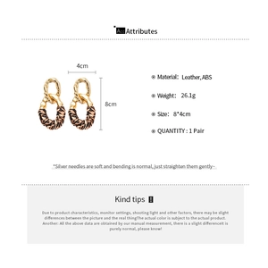 Detail of leopard print oval drop earrings with 8x4cm dimensions and silver needles