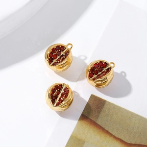 Macro view showing 18K gold plated fruit charms with sparkling red cubic zirconia seeds