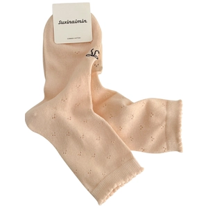 Pink combed cotton mesh socks with scalloped cuffs and butterfly pattern on white background