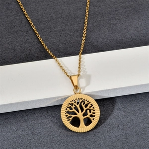 Golden Tree of Life pendant necklace in stainless steel displayed on a white stand