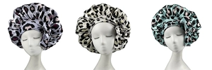 Detailed view of three leopard print satin sleep bonnets in purple, beige and teal colors