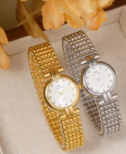 Detail of luxury gold and silver quartz watches with pearl chain bands and rhinestone markers