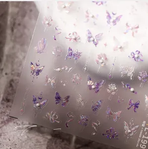 Macro shot of 3D aurora laser butterfly nail stickers with floral patterns and pearls