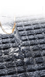 Close-up of water absorption on dark grey non-slip rubber mat for kitchen and entry