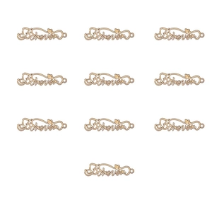 Close-up of 10 golden alloy infinity heart pendants with Forever engraving for DIY crafts