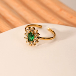 Adjustable gold stainless steel ring featuring emerald green zircon in sunburst setting