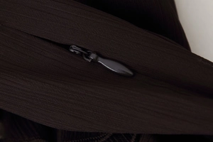 Macro detail of high-quality invisible zipper closure on coffee brown midi dress