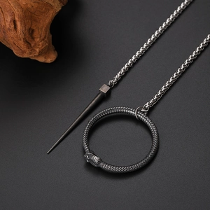 Retro black stainless steel Ouroboros snake pendant necklace with spike on dark background