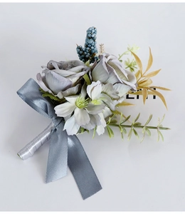 Detailed shot of vintage dusty purple silk roses with gray ribbon and blue berries