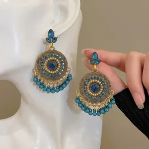 Ethnic bohemian drop fringe earrings with blue rhinestones in vintage gold finish