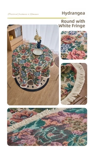 Detail of round jacquard tablecloth with hydrangea patterns and white fringe tassels