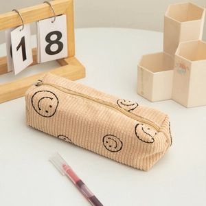 Close-up of corduroy pencil case texture featuring embroidered black smiley faces