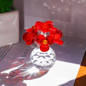 Macro shot of faceted red crystal flower ornament with a clear base in bright light