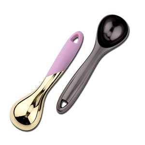 Dual ice cream scoops in gold with pink handle and sleek black finish on white background