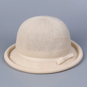 Detailed view of beige knit cloche hat featuring a fine mesh texture and chic bow tie