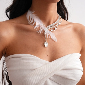 Detailed view of silver feather necklace with sparkling crystals on female neck
