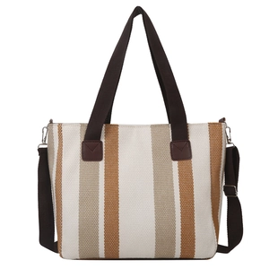 Vertical stripe canvas tote bag with brown handles and adjustable shoulder strap