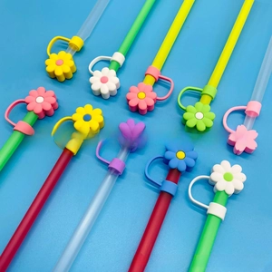 Macro shot of colorful floral silicone straw covers for 10mm cups on a blue background