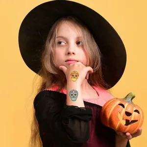 Halloween skull temporary tattoo stickers for kids on forearm with pumpkin prop