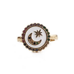 Macro detail of gold-plated celestial ring with moon, stars and multi-color zircon stones