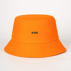 Detailed close-up of orange canvas bucket hat showing KING embroidery and stitched brim