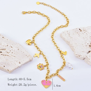 Detail of gold multi-charm necklace with AMOUR engraving, heart and flower pendants