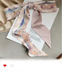 Detailed embroidery of Love Yourself text on elegant vintage pink silk scarf