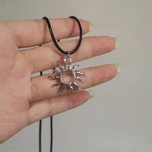 Silver sun pendant necklace with swirling rays on a black leather cord for men and women