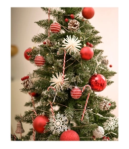 Detailed close-up of red and white Christmas tree ornaments with candy canes and pine cones