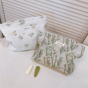 Floral cotton makeup bags with delicate botanical embroidery and simple wish label