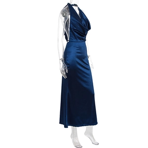 Close-up of deep blue satin cowl neck halter dress with open back and floor-length design
