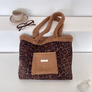 Close-up of leopard print tote bag featuring a teddy fleece pocket and brand label